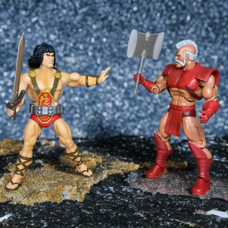 Super7 Ultimates! Kull the Conqueror action figure with sword drawn in combat pose facing off against Masters of the Universe Classics Geldor figure holding battle axe, side-by-side collector comparison of fantasy barbarian warriors.