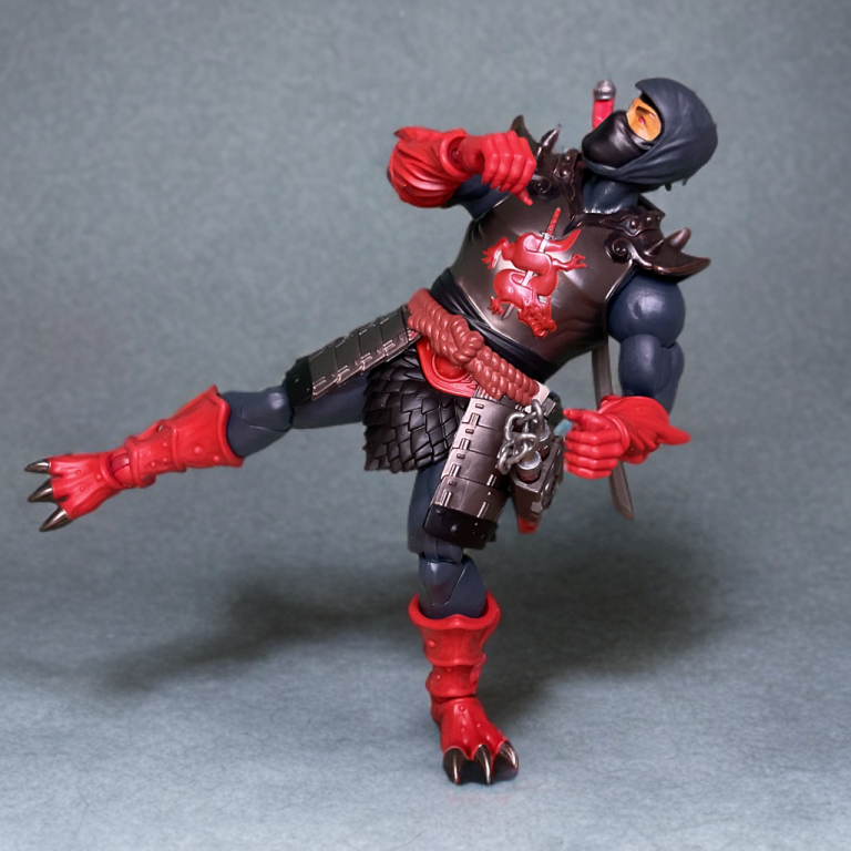 Masterverse Ninjor in a high-kick pose, showcasing 30 points of articulation, with red shoulder pauldrons and chain mail skirt slightly limiting hip movement.