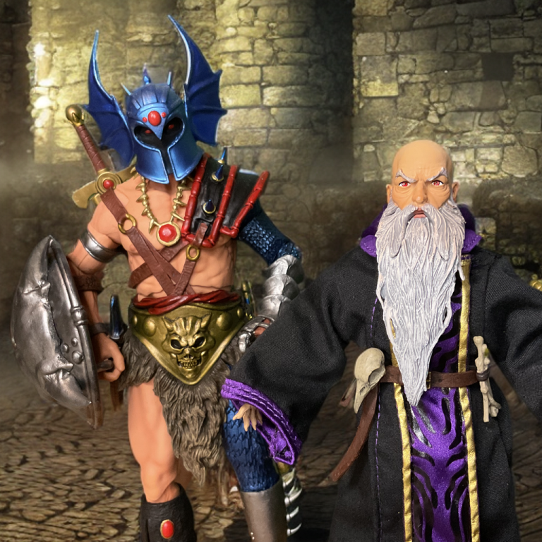 Warduke und Arrizak posieren zusammen in einem Fantasy-Diorama.