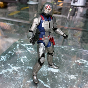 Dynamic pose of battle armor Cobra Commander on an abstract background.