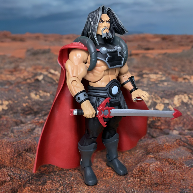Muscular figure of Count Marzo in black armor and red cape, holding a red-tipped sword on a rocky desert landscape under a cloudy sky.