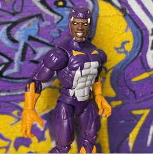 Cottonmouth, a Marvel villain with a menacing bionic jaw, standing in front of a graffiti covered wall with a snake-themed costume, ready for combat.