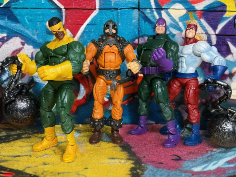 The Wrecking Crew standing in front of a wall of graffitis.
