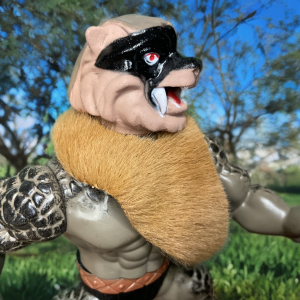 Primer plano de la versión moderna del Guerrero Lobo en el bosque bajo un cielo azul.