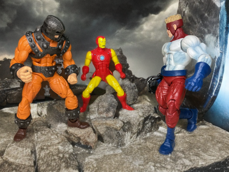 Bulldozer and Piledriver charging Iron Man on a rocky battlefield at dusk.