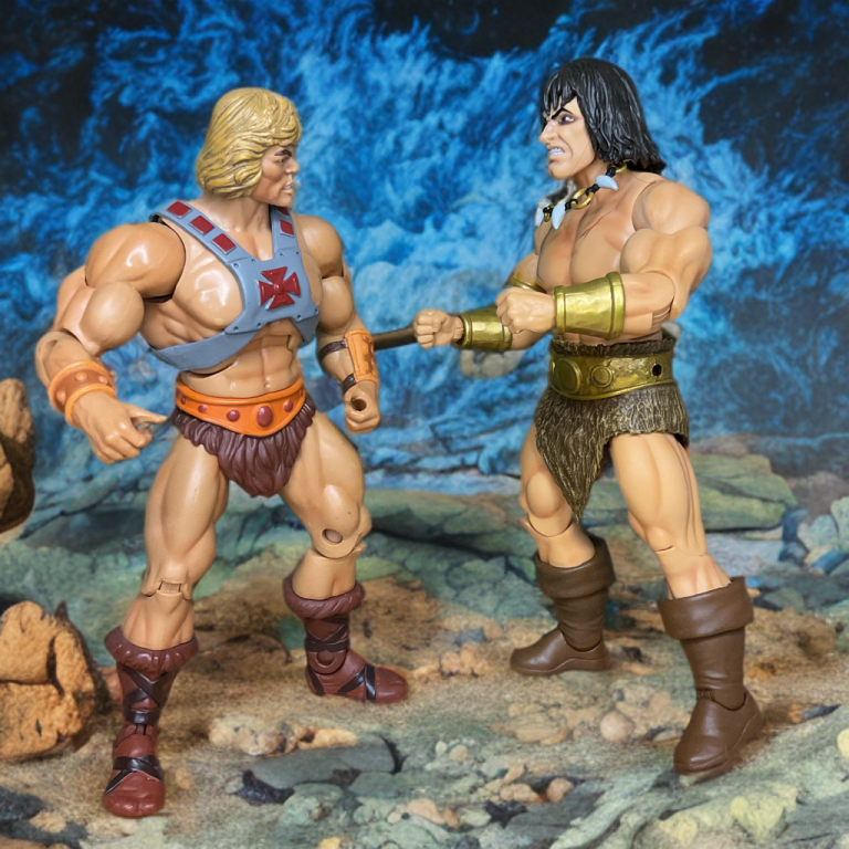 Conan and He-Man, both in loincloths glare across a thunderous rocky field.