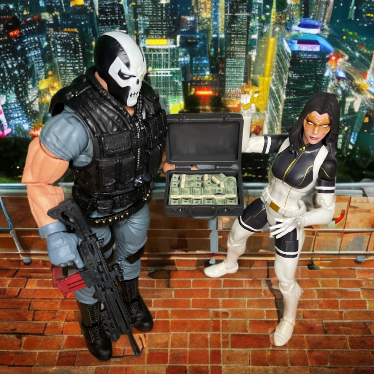 Crossbones and Madame Masque Marvel Legends figures staged in a mock heist scene, with Masque pointing and Crossbones with a submachine gun.