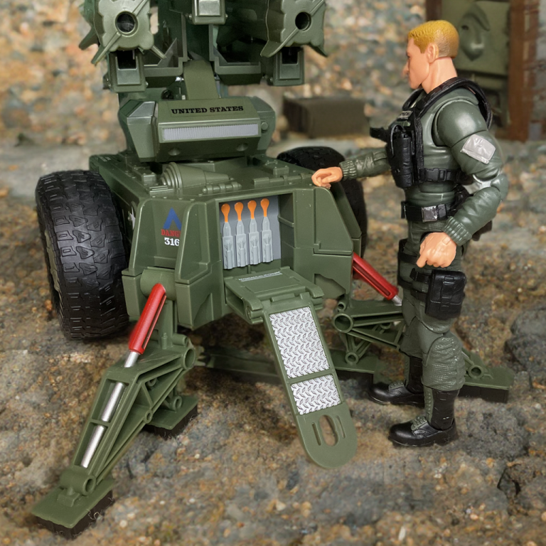 Hawk figure in tactical pose by the Mobile Missile System’s control panel, with its launcher arm elevated and missiles loaded.