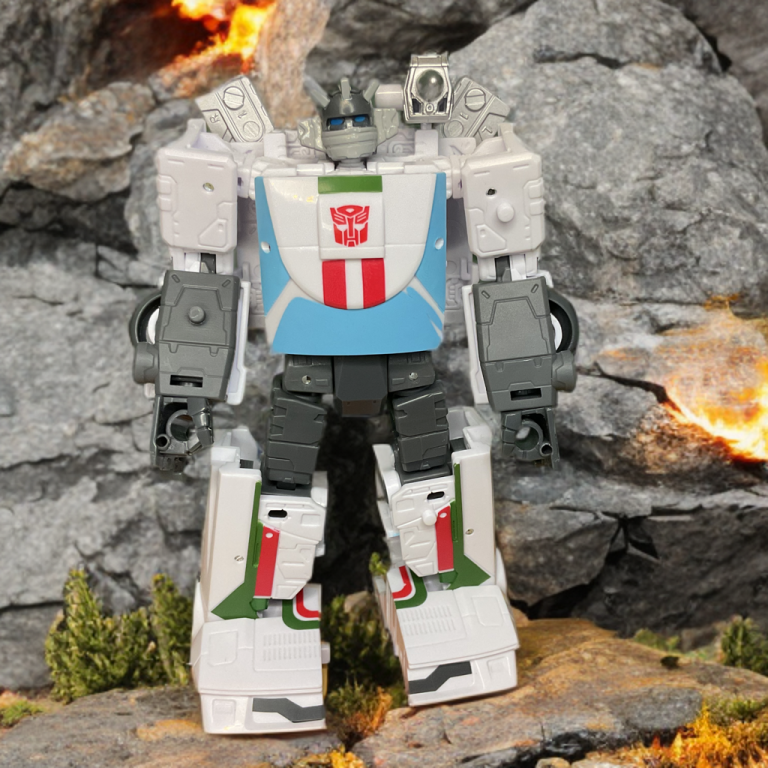 Wheeljack in robot mode, showcasing G1-inspired helmet with vent ears and blue visor eyes, posed with shoulder cannons ready.