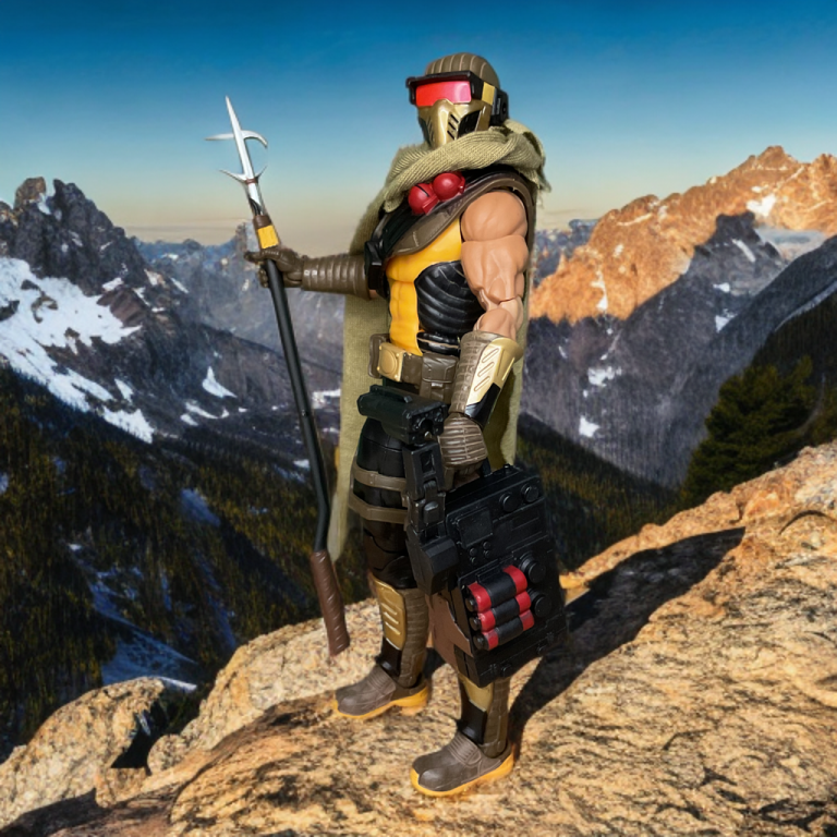 The Cobra Desert Scorpion action figure, clad in tan and black armor, holds a grapple launcher.