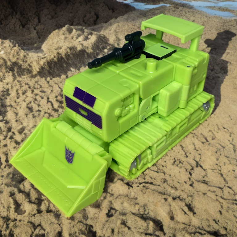 Bonecrusher in vehicle mode bulldozing through the sand.
