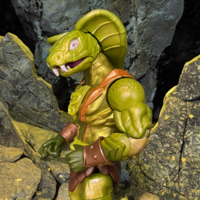 A close-up of the 2025 Masterverse New Eternia Kobra Khan action figure, showcasing its green scaled torso and flared cobra hood against a blood-red Eternian ruin backdrop.