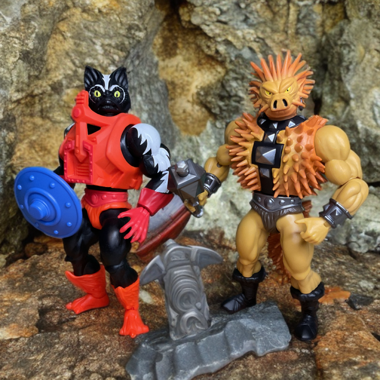 Stinkor and Spikor ready for battle in front of a rocky backdrop.