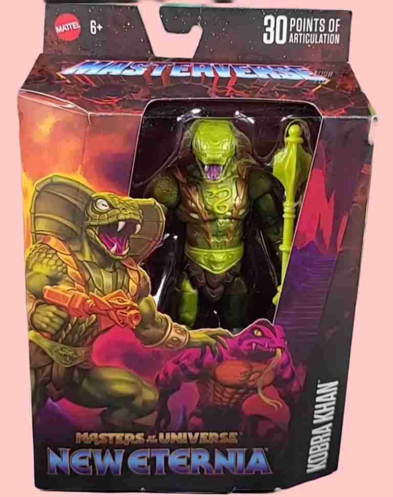 The Masterverse Kobra Khan figure displayed in its deluxe window box, featuring artwork of Eternia’s fractured ruins and the figure’s menacing pose.