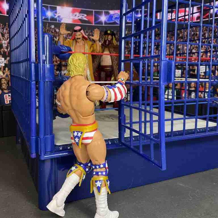 Lex Luger vaults over cage rope, stars-and-stripes trunks gleaming.