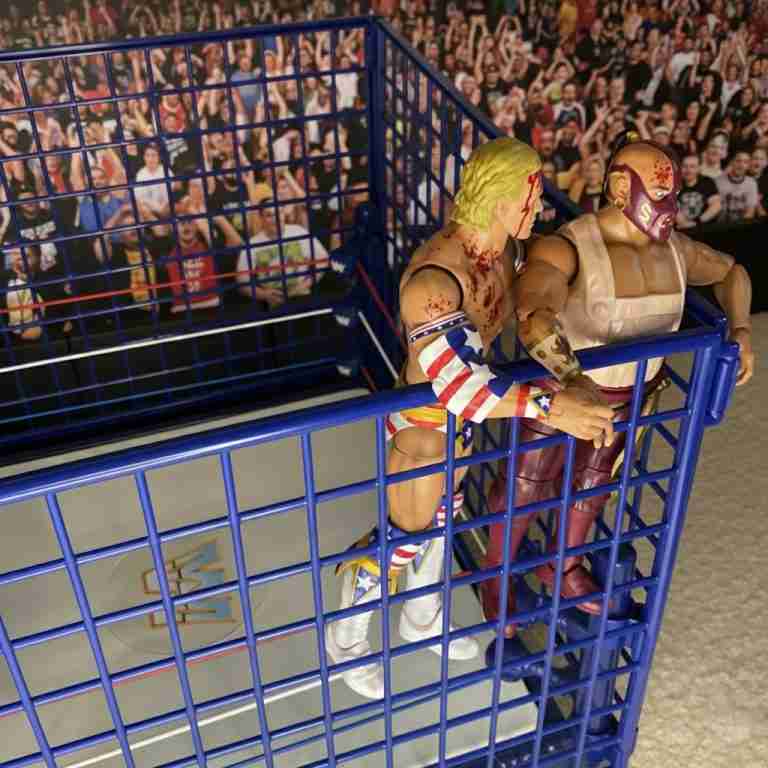 Luger yanks climbing Sultan off cage wall by the ankle.