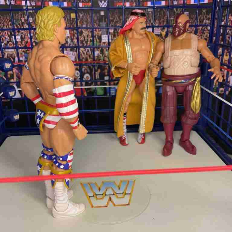 Luger and Sultan lock eyes across ring, cage door clanging shut.