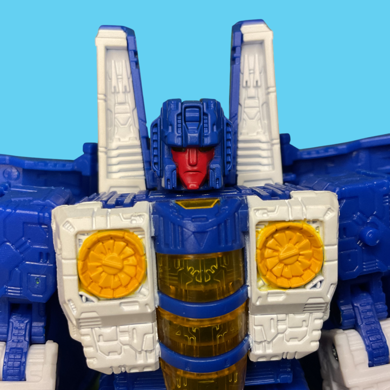 Nacelle’s robot head sculpt in profile: Translucent red visor, etched mouthplate sneer, and sharp asymmetrical helmet wings.