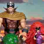Marvel Legends Gorgon and Medusa posed in front of a sunset background.